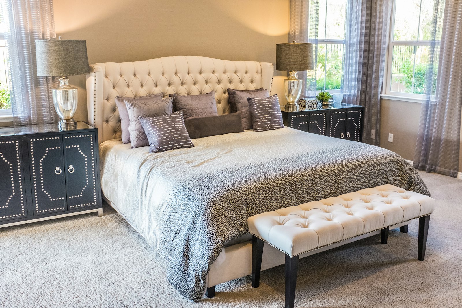 A calm, neatly made bedroom with soft bedside lamps