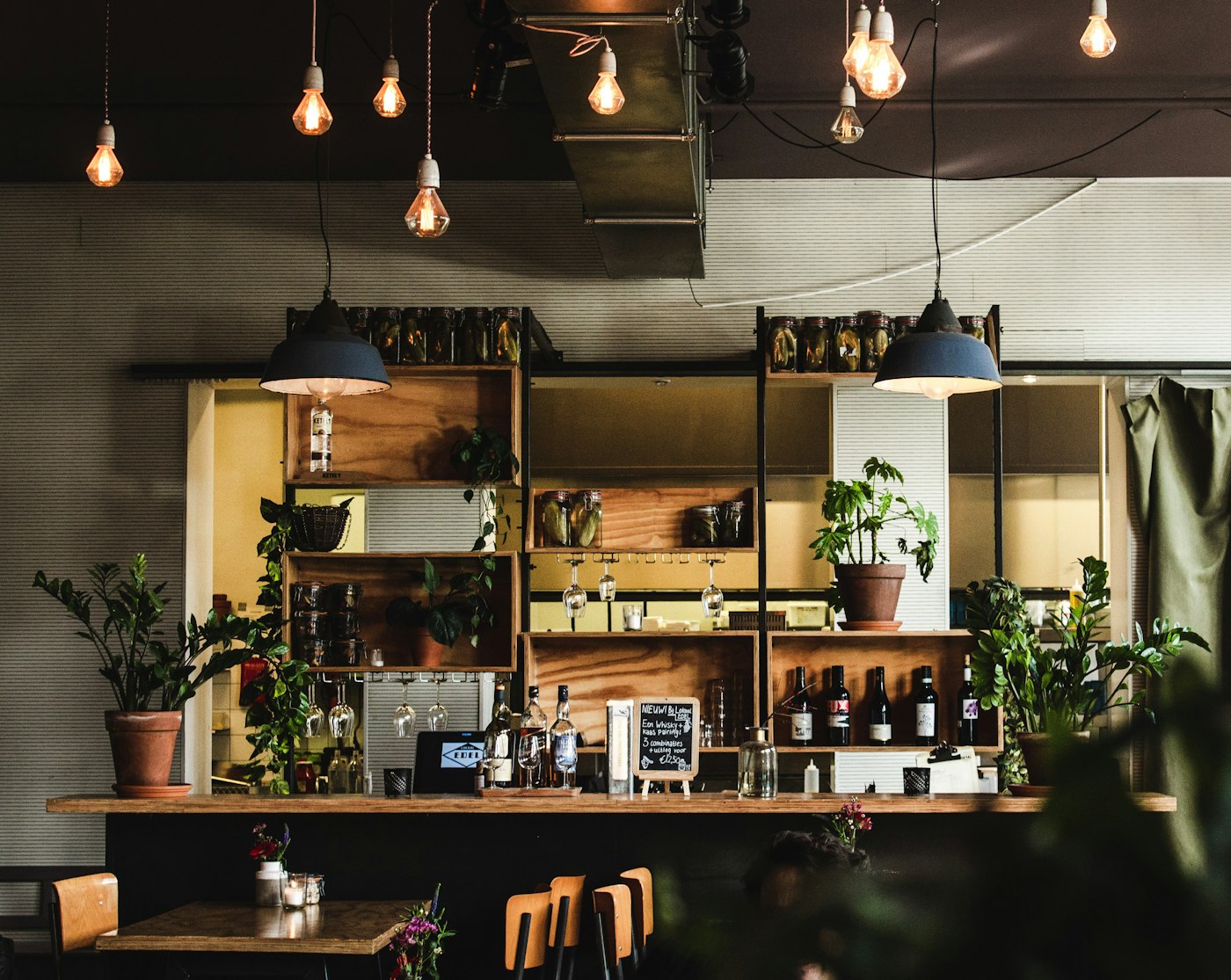 The ConnectionCafe.com counter in Shoreditch, with hanging lights, plants and the espresso machine