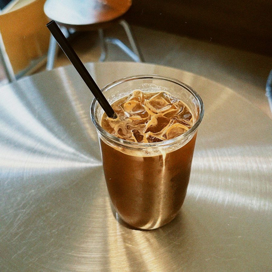 Iced cold brew coffee served over ice in a tall glass with a straw