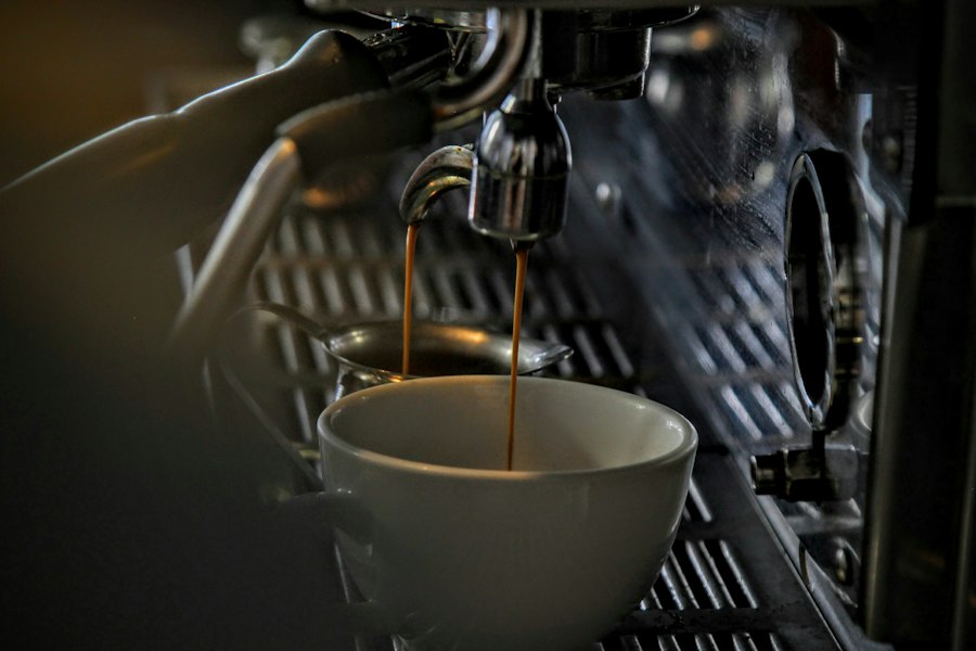 A double espresso extracting from the group head into a porcelain cup at the ConnectionCafe.com coffee bar