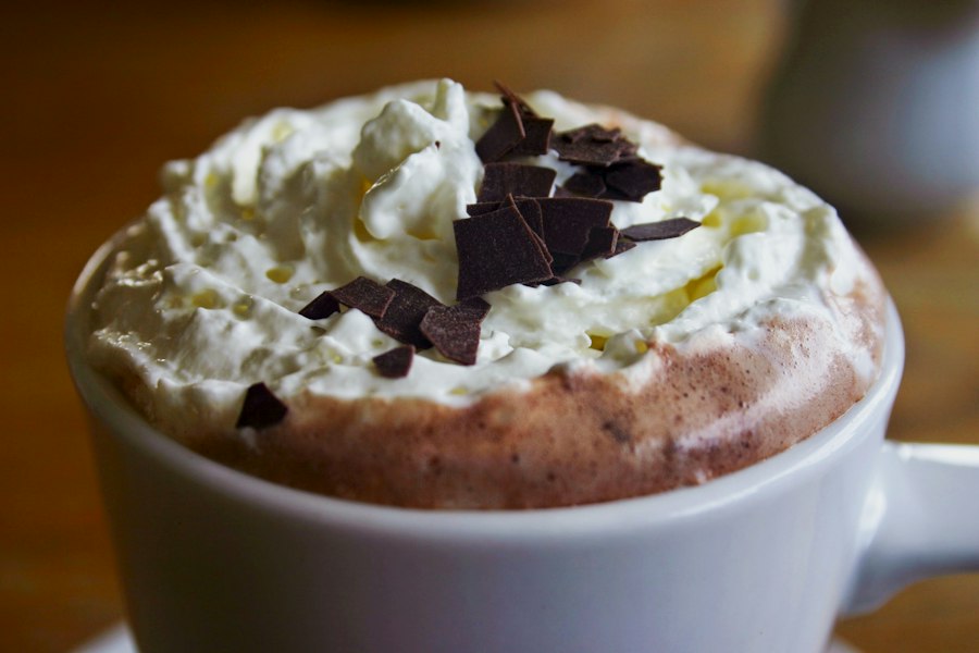 Mocha topped with whipped cream and chocolate shavings in a ceramic mug