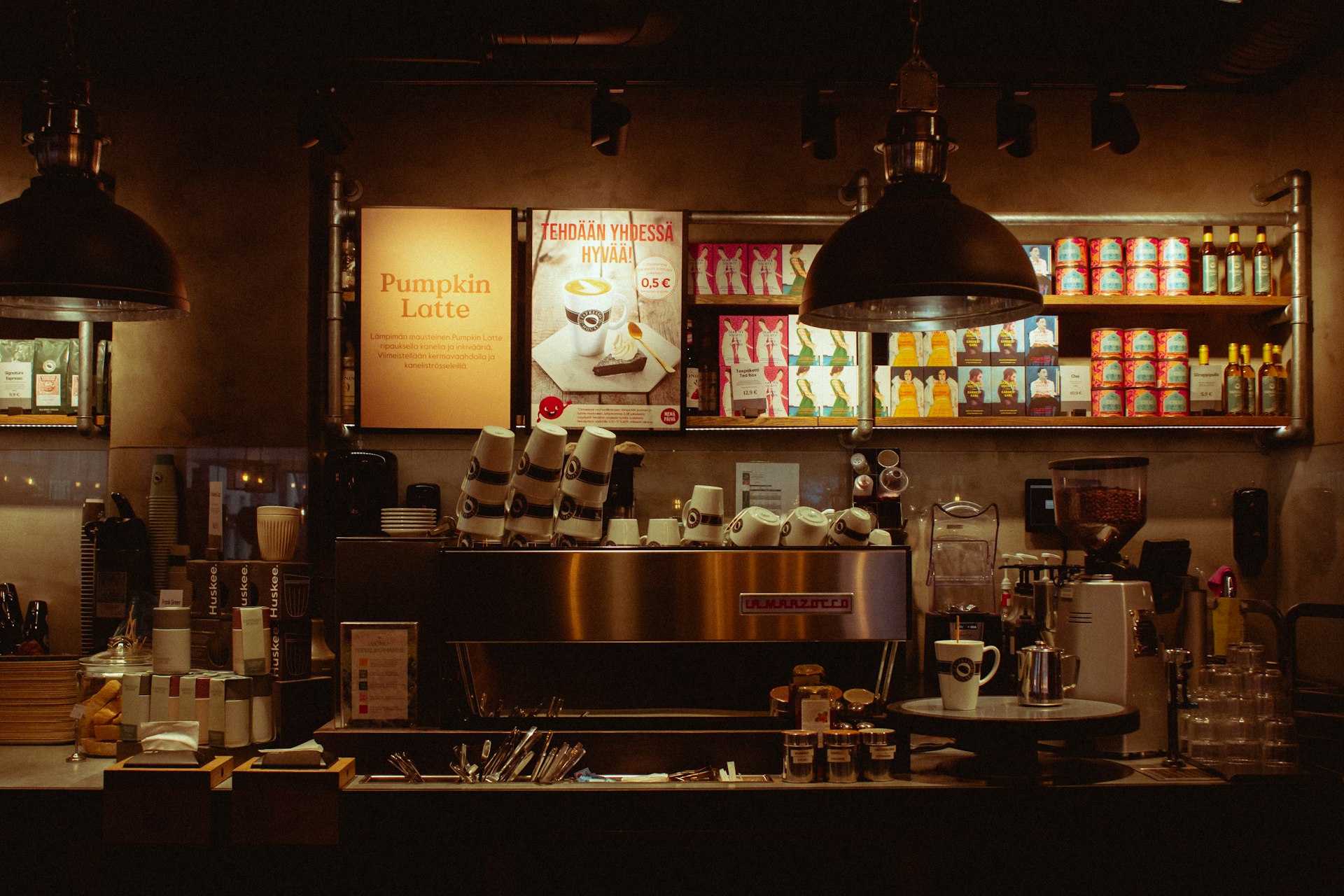 The ConnectionCafe.com coffee bar in Shoreditch at dusk, with pendant lamps over the espresso counter