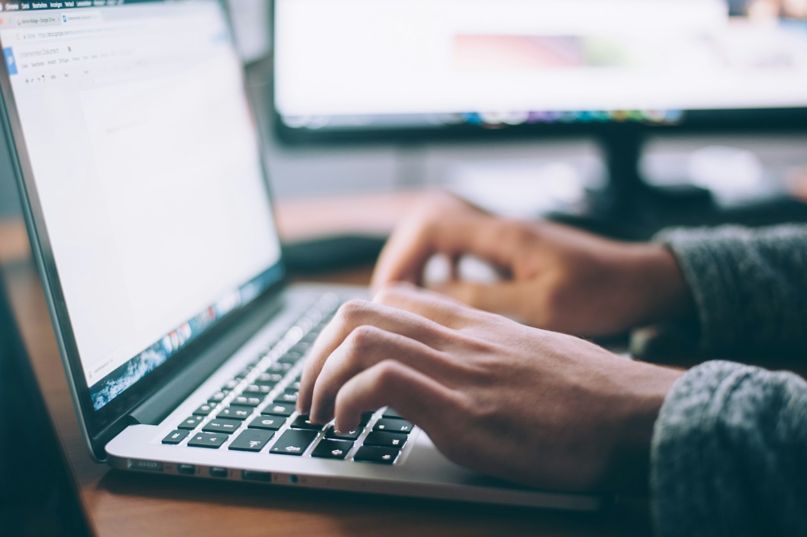 Hands typing on a silver laptop, the kind of everyday machine that can slow down over time