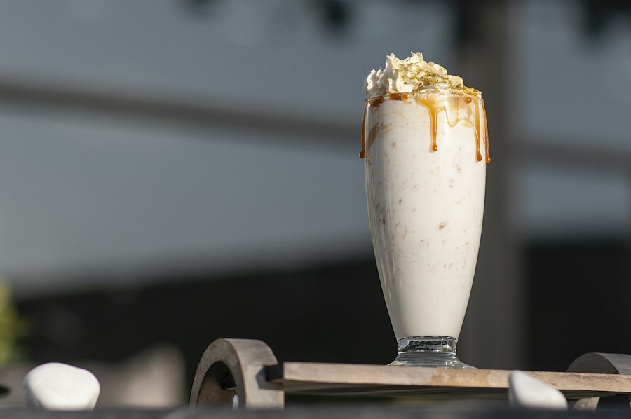 Salted caramel milkshake with caramel drizzle served in a classic soda glass